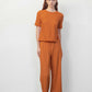 woman in orange T-shirt and pants