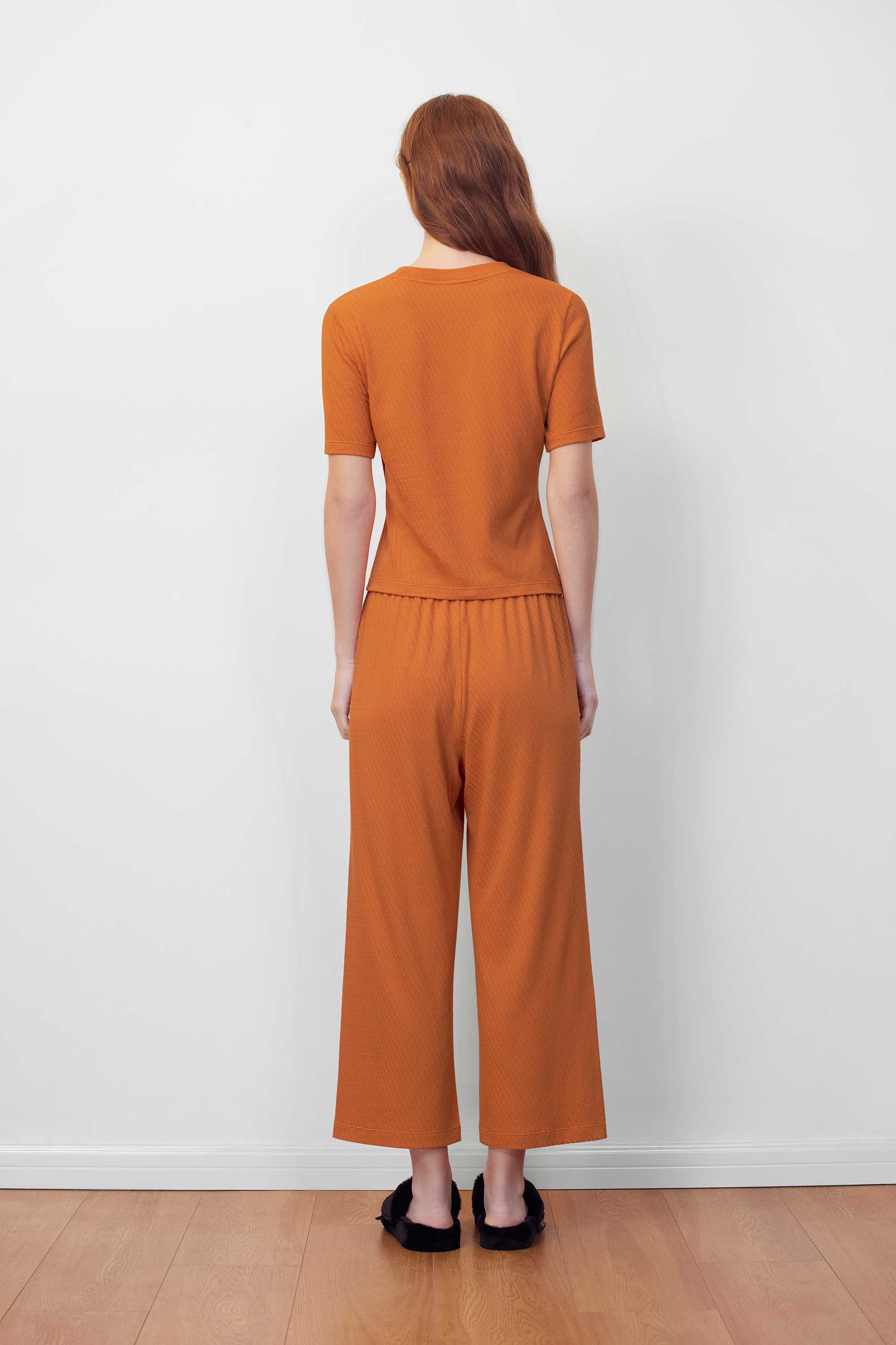 back of  orange T-shirt and pants
