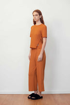 woman in orange T-shirt and pants