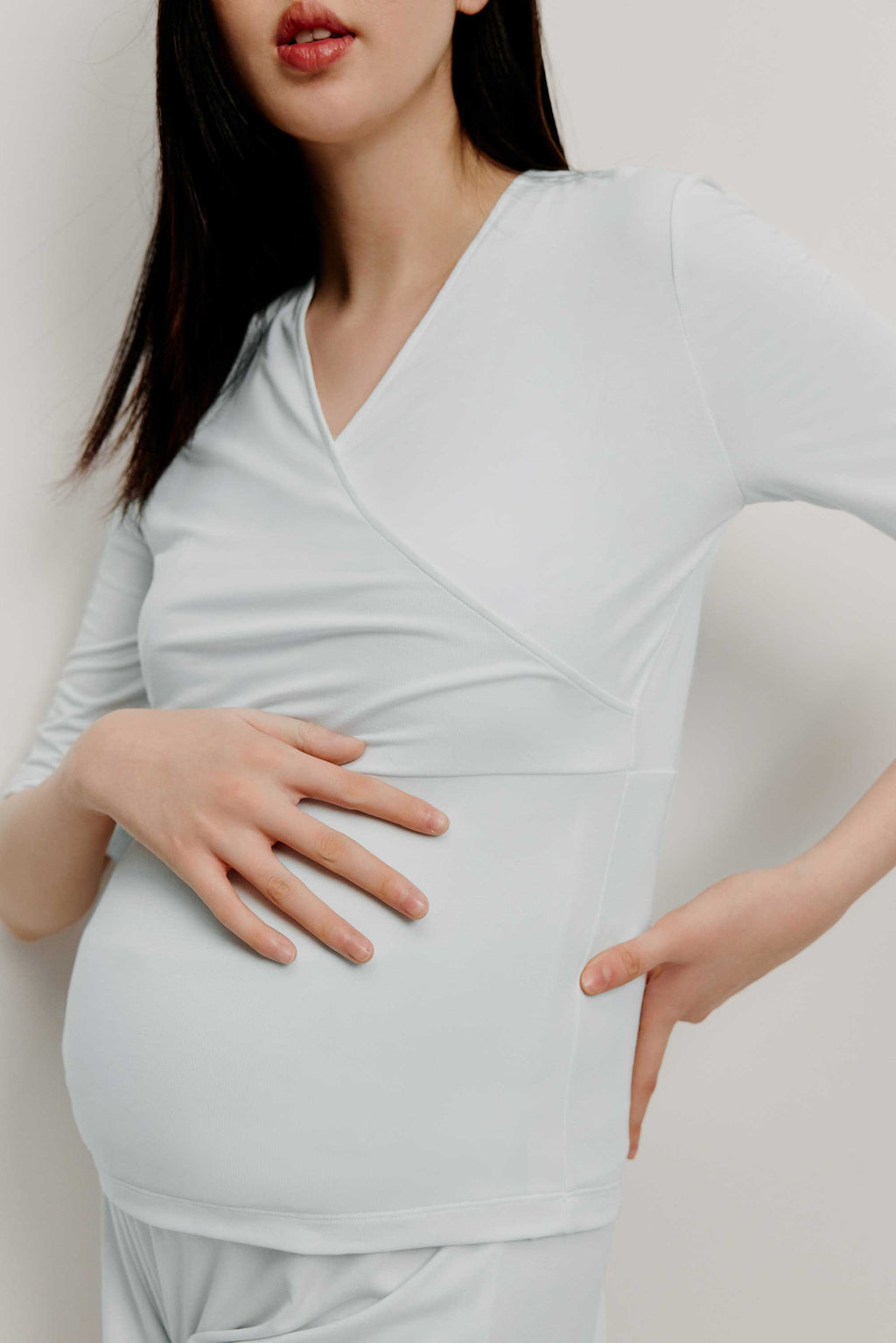 Pregnant woman wearing maternity V-neck top