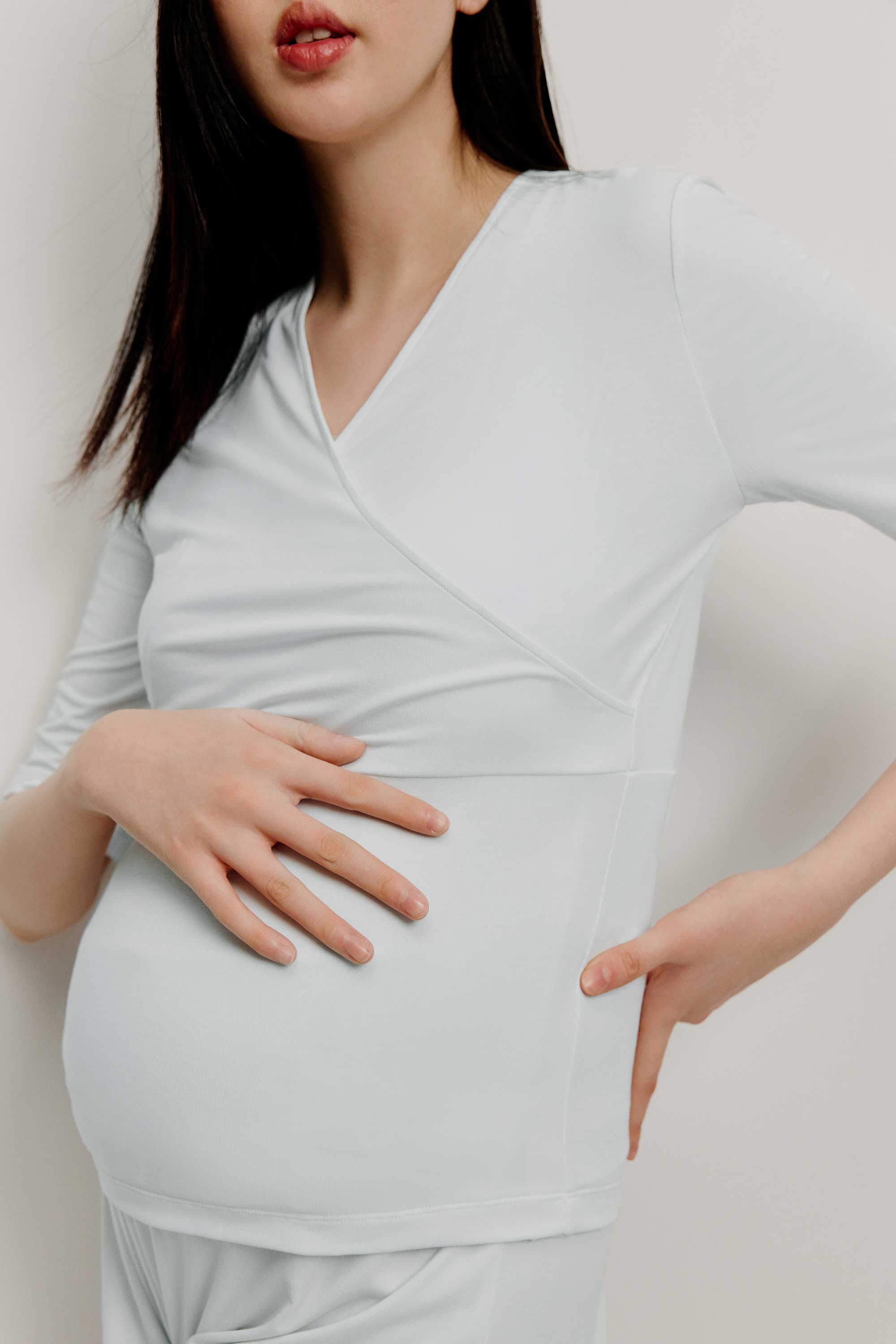 Pregnant woman wearing maternity V-neck top