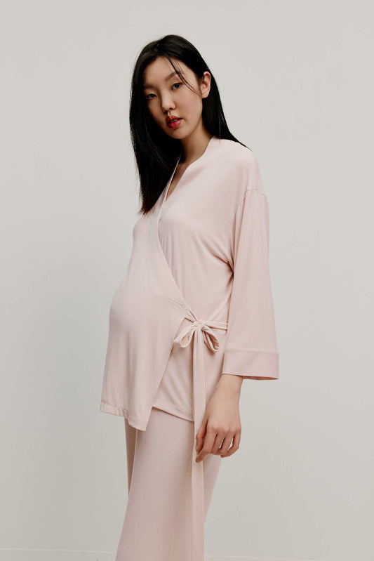 Pregnant woman wearing maternity wrap top