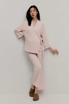 Pregnant woman wearing maternity wrap top and pants