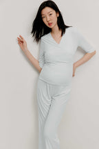 Pregnant woman wearing maternity V-neck top and pants