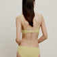 back of woman in yellow bra and brief
