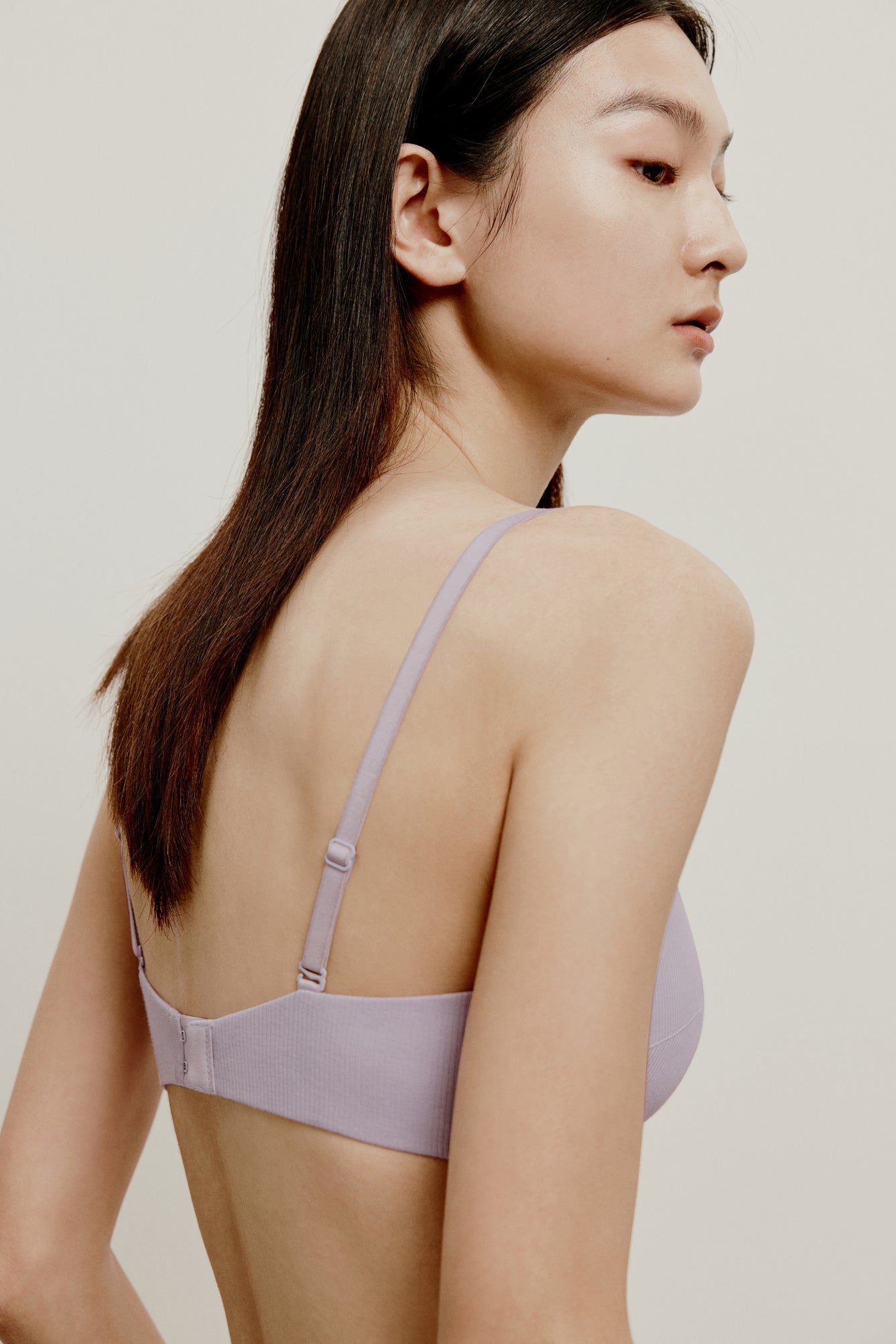 back of woman in light purple bra