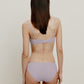 back of woman in light purple bra and brief