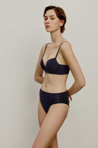 woman in dark purple bra and brief