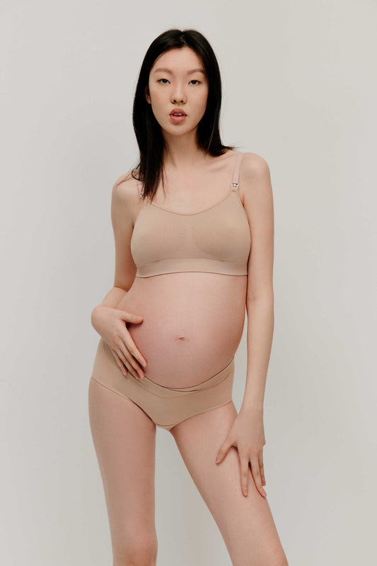 pregnant woman in nude color bra and underwear