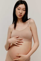 pregnant woman in nude color bra and underwear