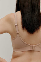 back of woman in nude bra