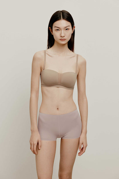 woman in tan color bra and light purple brief