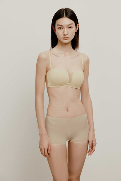 woman in cream color bra and nude brief