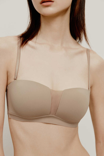 close up of woman in tan color strapless bra