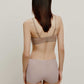 back of woman in tan color bra and light purple brief
