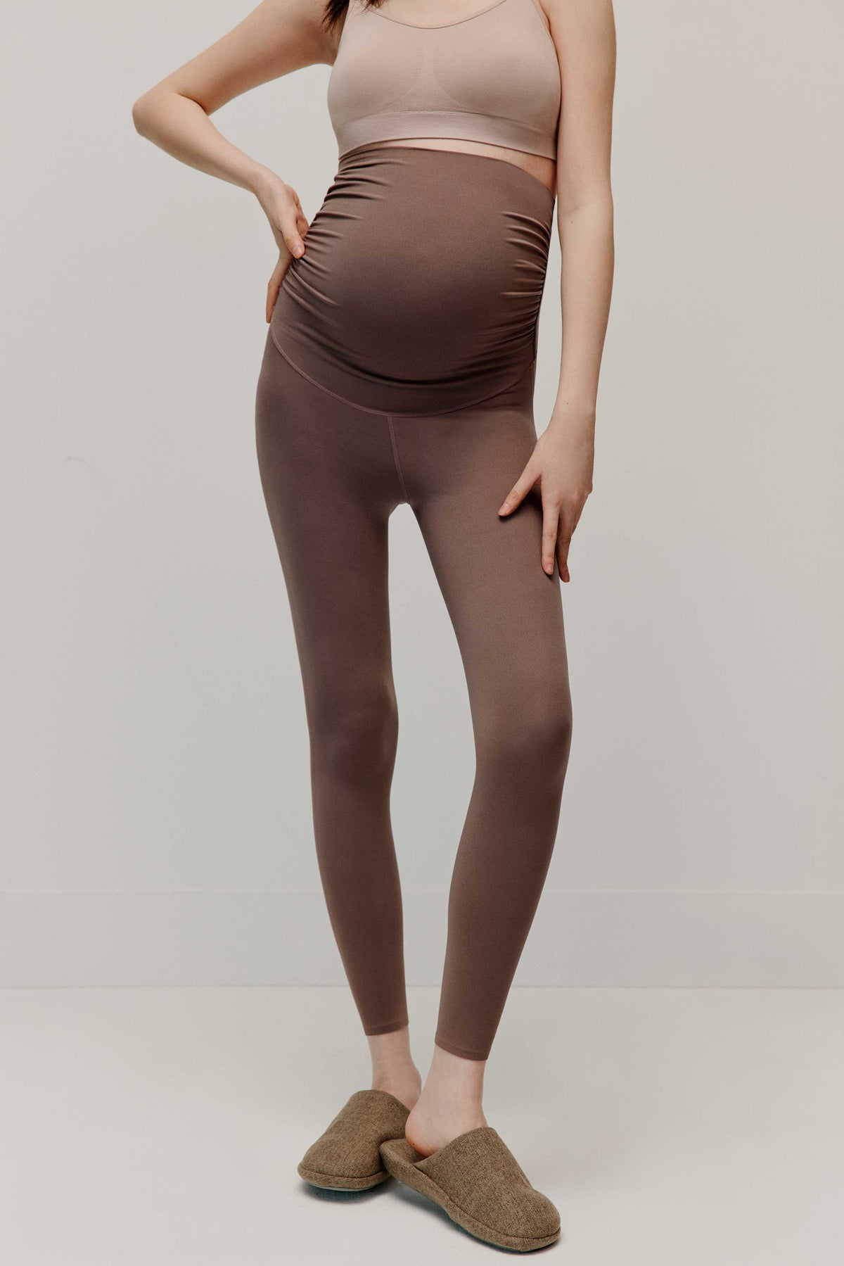 pregnant woman in high waist brown leggings