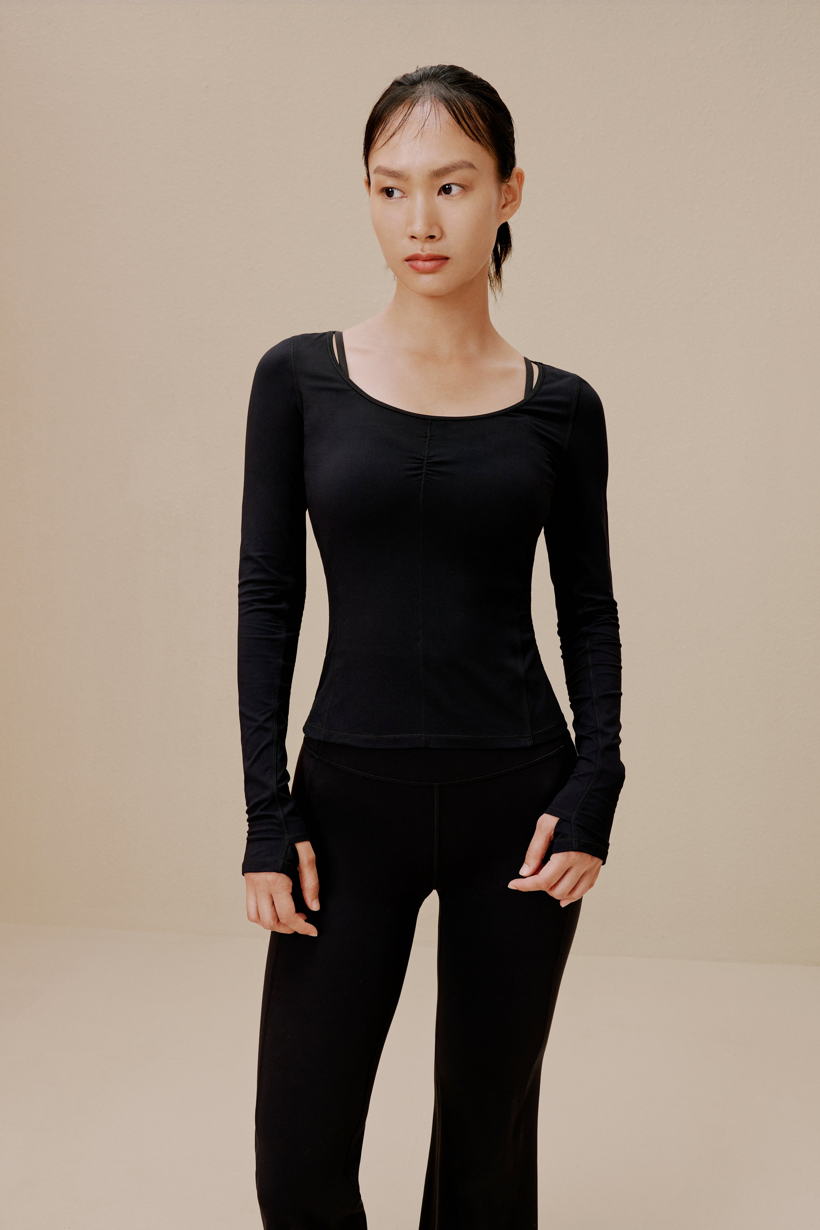 Woman in black top and sweatpants