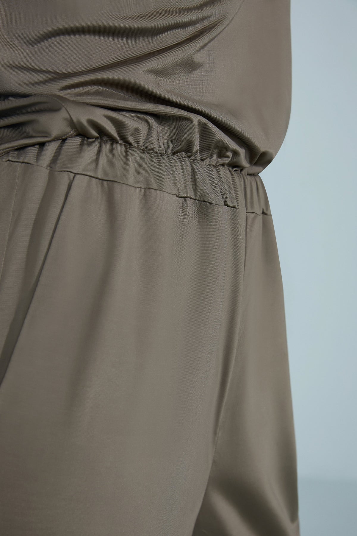 NEIWAI Back Twist Cowl Neck Jumpsuit in Burnt Olive. Flexible waistline