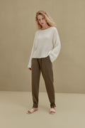 women in white knitted top and brown joggers