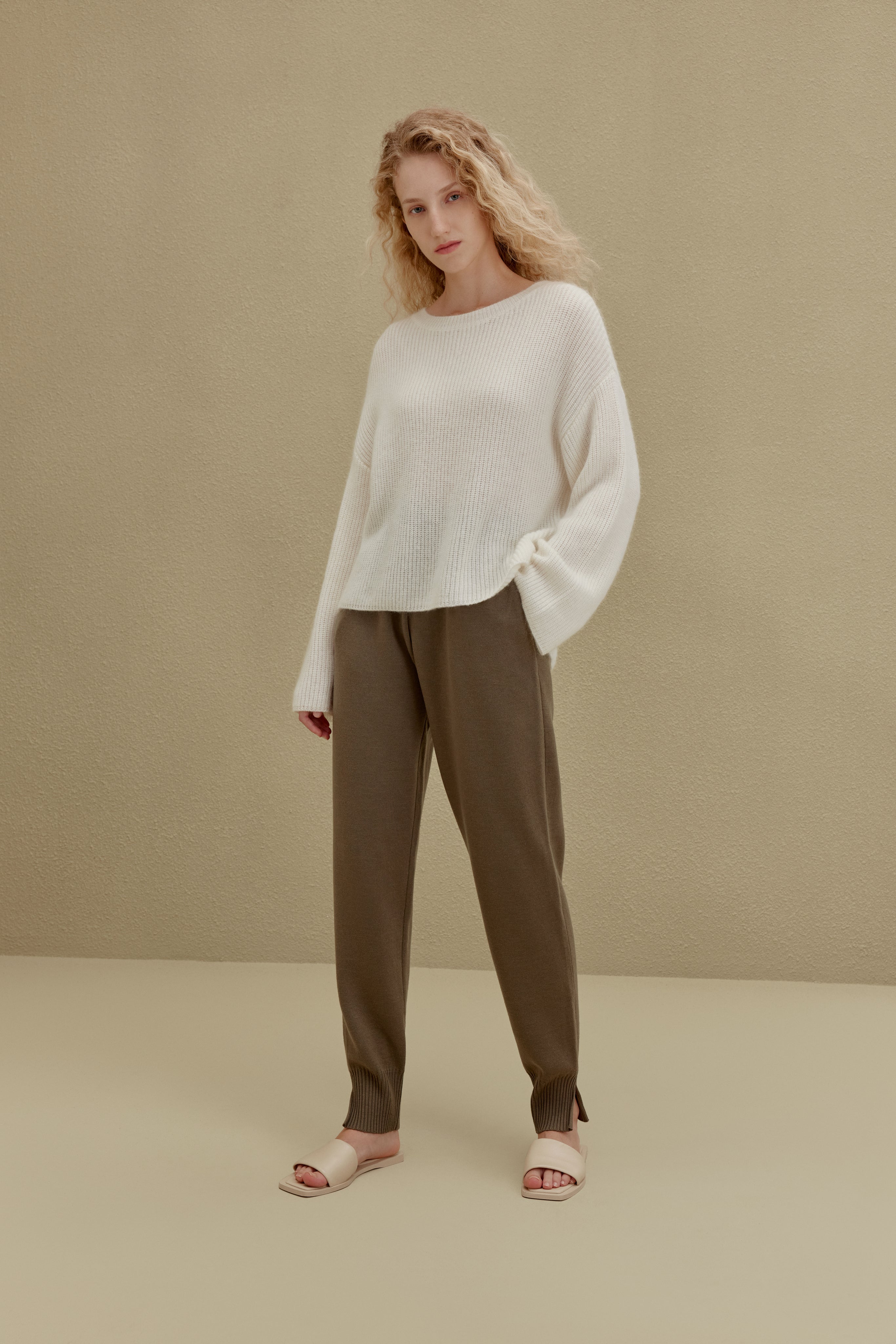 women in white knitted top and brown joggers