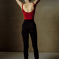 woman wearing red tank top and black stirrup leggings back